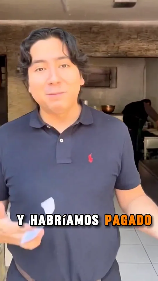 A man in a navy polo talks to the camera in a pizzeria, captioned And we would have paid