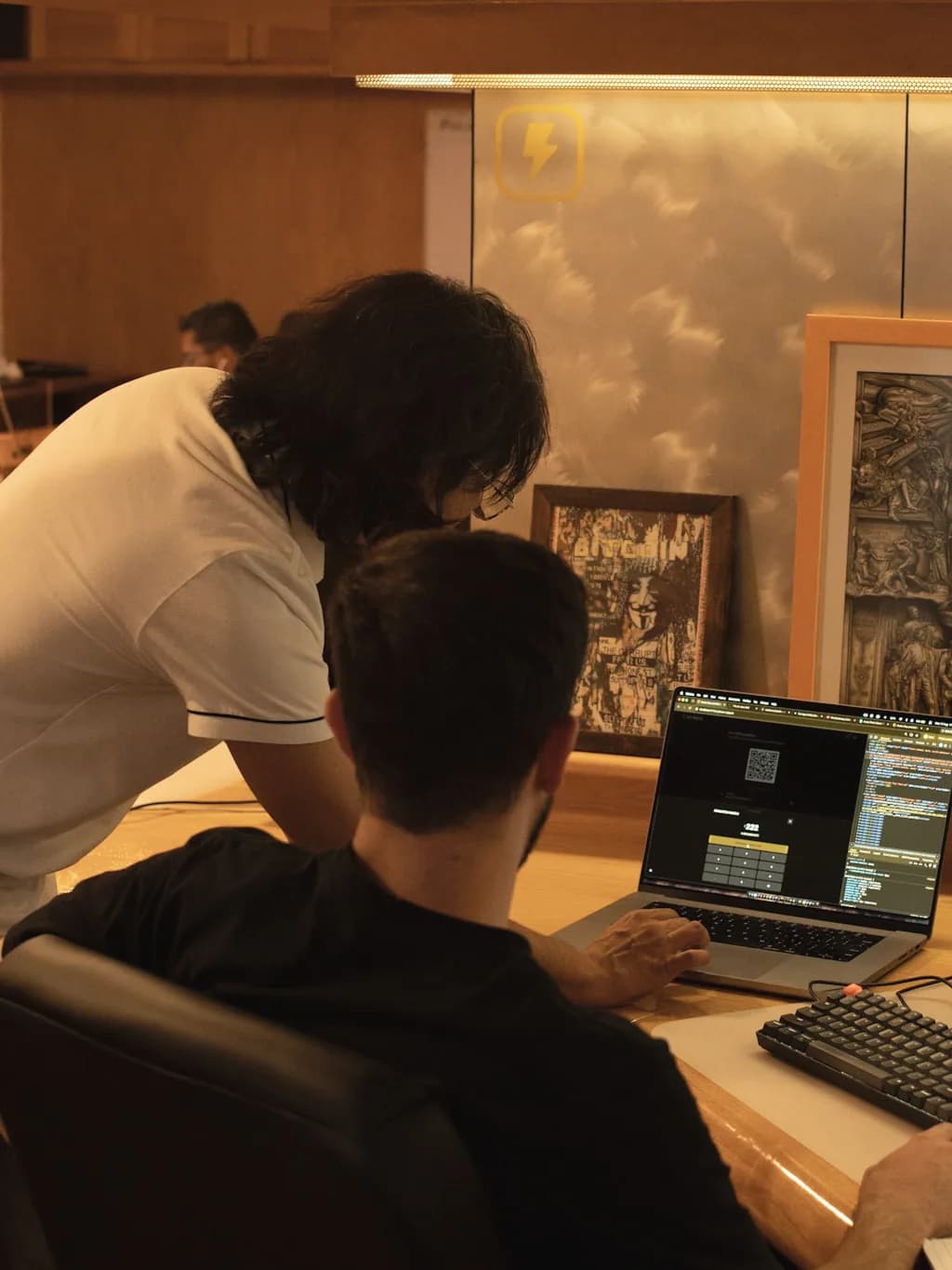 Two Aureo engineers reviewing the application on a laptop